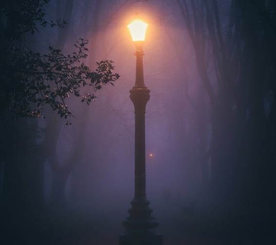Streetlamp glowing in darkness representing Balki International’s focused vision and guidance in international trade