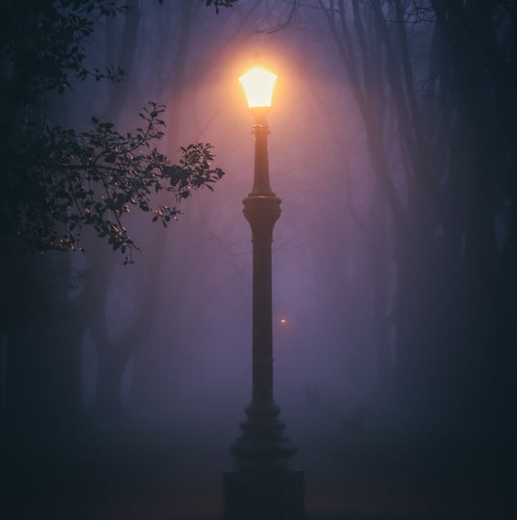 Streetlamp glowing in darkness representing Balki International’s focused vision and guidance in international trade