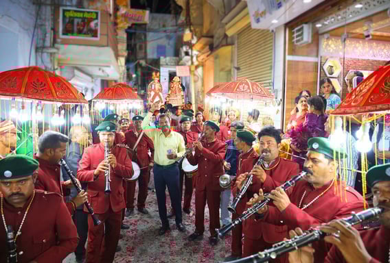 Manohar Brass Band, with their master in the middle, marching with Gangaur, exuding enthusiasm among the crowd.