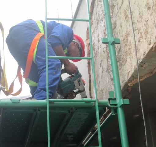 Mechanical stripping of compromised exterior plaster for waterproofing works, Sandhurst Towers, Sandton