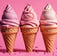 three ice cream cones with pink and white icing