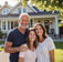 Smiling homeowner with family in front of remodeled house by Garnet Painting & Remodeling GA