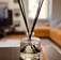 Verve Reed diffuser made of glass with black reeds with foggy modern living-room backgrounf