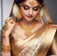 a woman in a gold and white sari