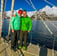 a couple standing on a sailing yacht in a ski and sail advenure in Norway | Jolly Good Times Sailing