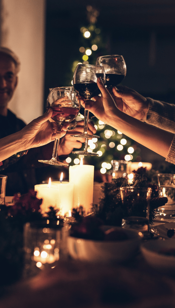 a group of people toasting with wine glasses
