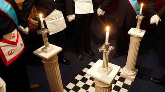 a group of men in formal attire standing in a room
