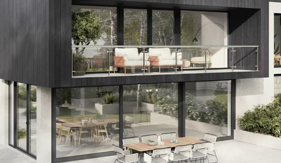 a modern house with a balcony and a table with chairs
