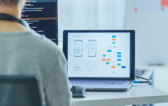 person working on sequence model with a laptop and computer monitor