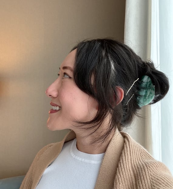 A photo of Yuko looking to the left and smiling