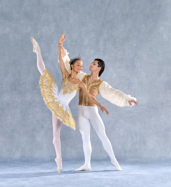 a couple of dancers performing in a ballet pose