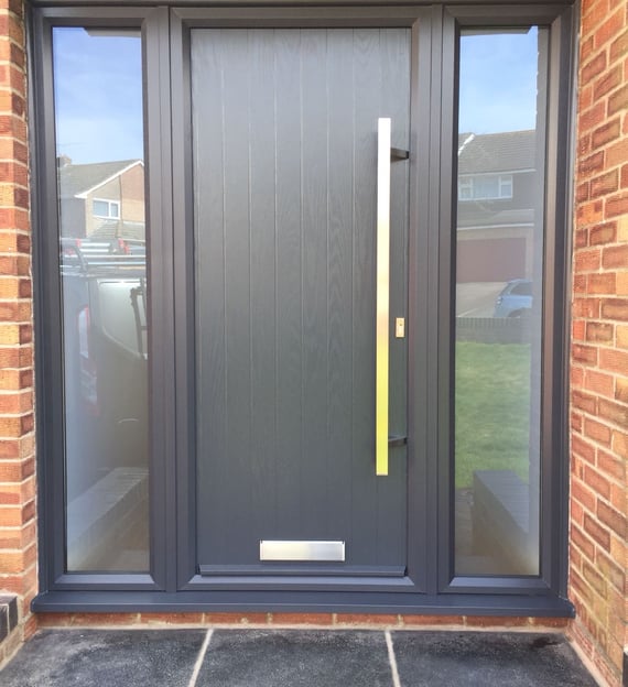 modern grey composite door with no glass.  Ral 7016 coloured frame.  2 side panels 