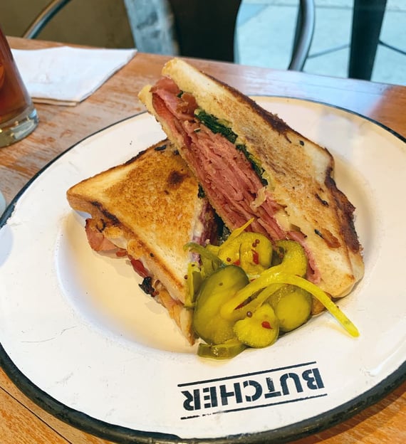 a sandwich with pickles on a plate