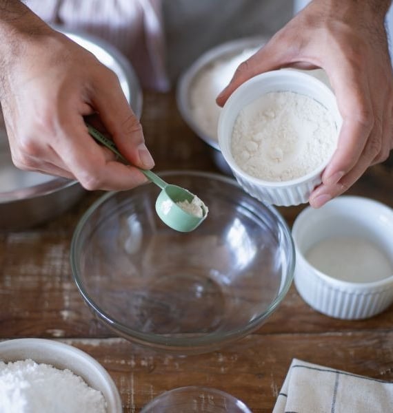 a person is holding a spoon and spoon in their hands