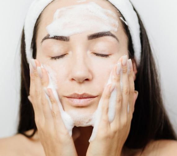 woman washing her face