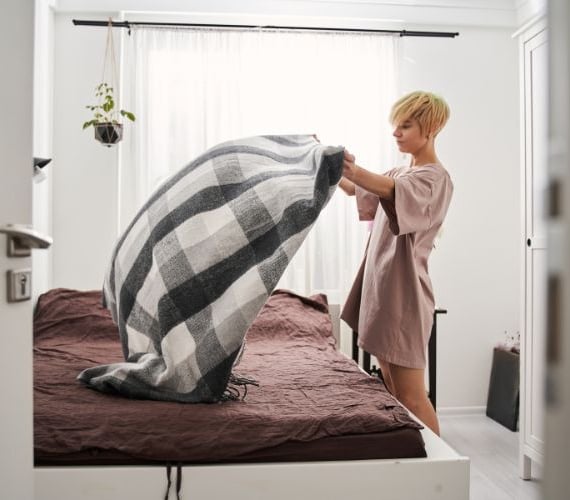 woman making her bed