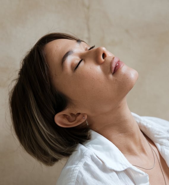 a woman doing face yoga