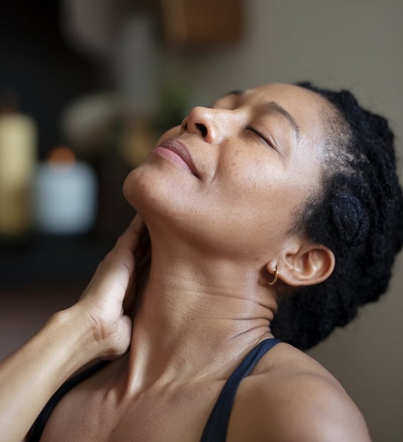 a woman with her hand on her neck