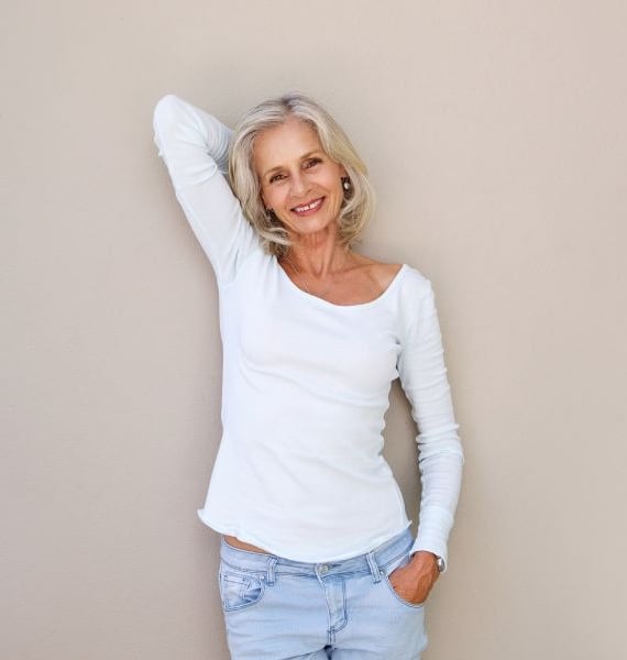 confident woman in a white shirt and jeans
