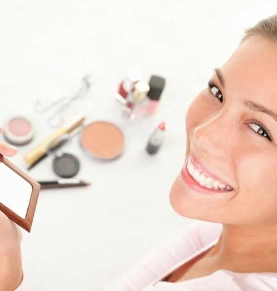 a woman holding a mirror in her hand
