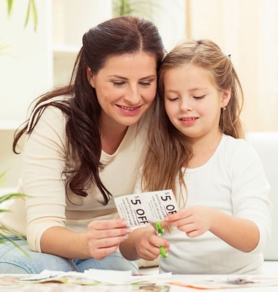 woman clipping coupons