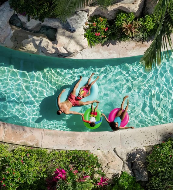 two people in swim suits are floating in a pool