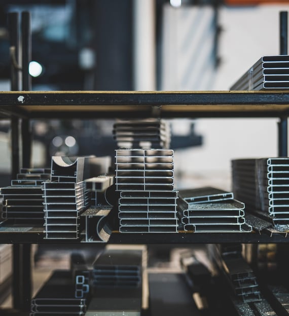 a shelf of metal pipes and pipes in a warehouse