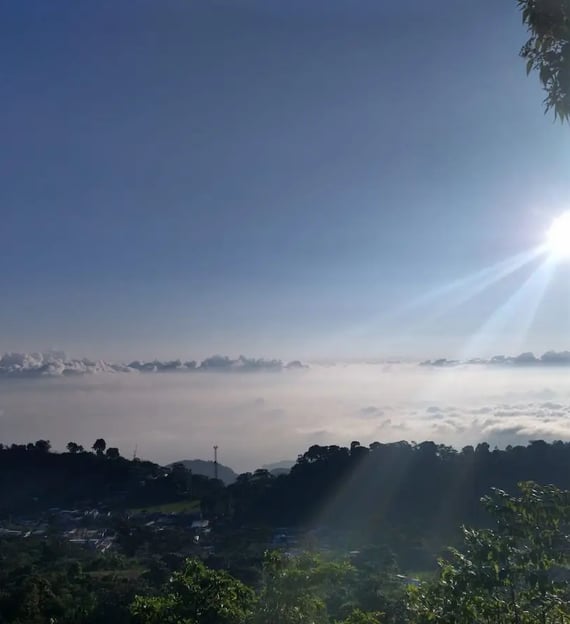 a view of the sun shining through the clouds