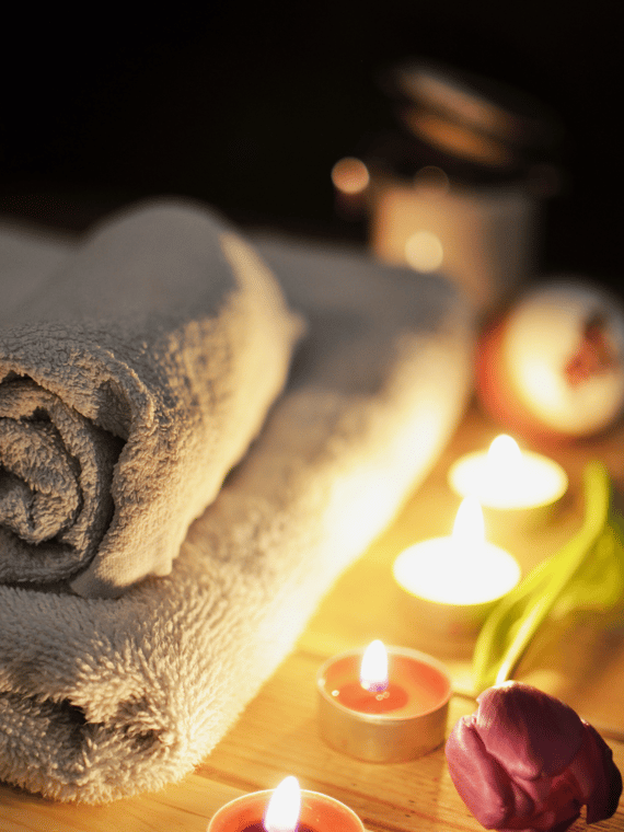 a towel towel on a table with candles and candles