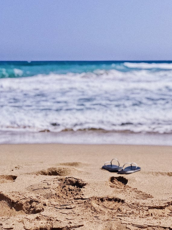 a pair of flip flop on the beach