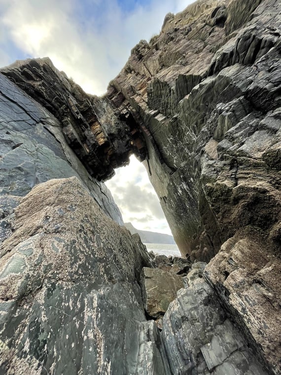 a rock formation next to sea