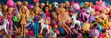 a bunch of dolls dolls and toys on display