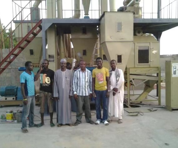 a group of men standing in front of a machine