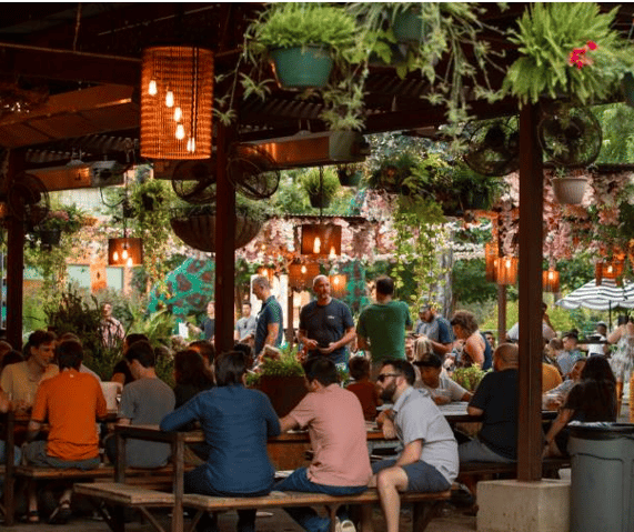 a group of people sitting at tables in a restaurant