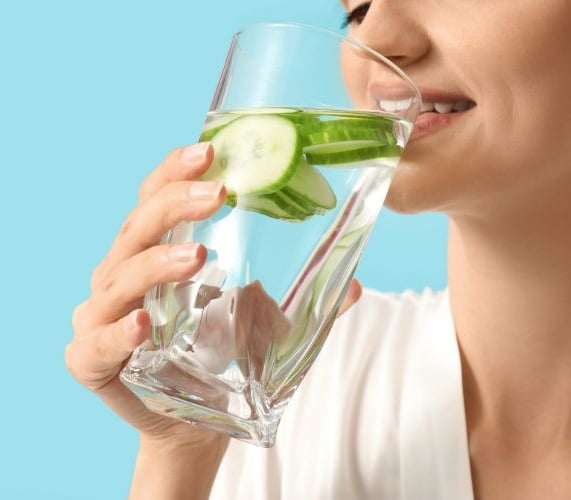 woman drinking cucumber water