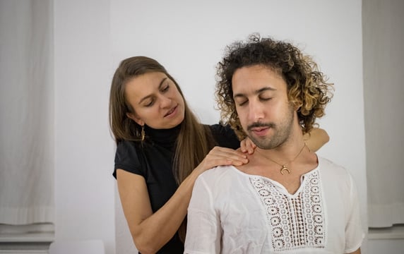 a woman massaging mans shoulders