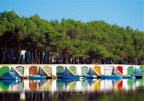 a row of boats in a row on the water
