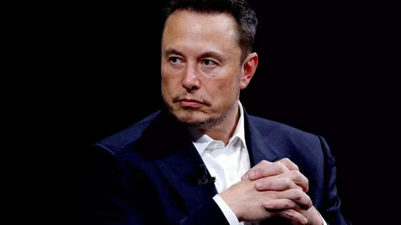 a man in a suit and tie is holding a cell phone