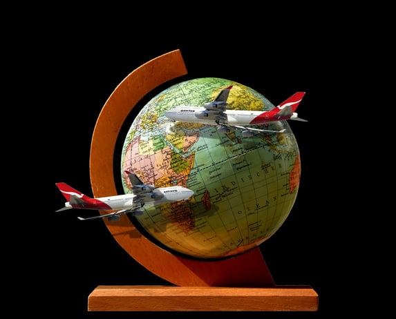 a globe globe with airplanes flying over a globe