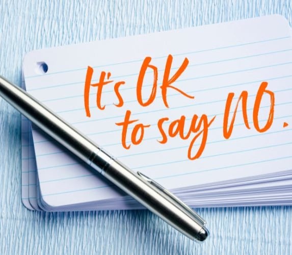 a pen and on a notebook with the words it's ok to say no