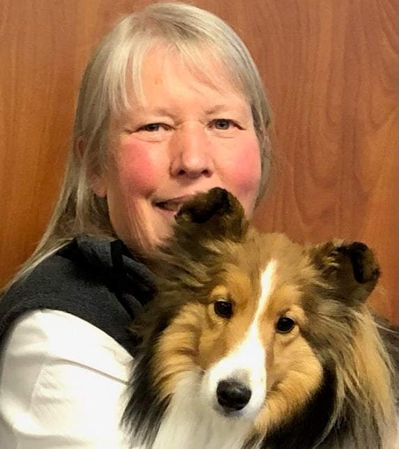 Kathy Temple, one of the original members of Tender Paws, holds her therapy animal, Lovie.