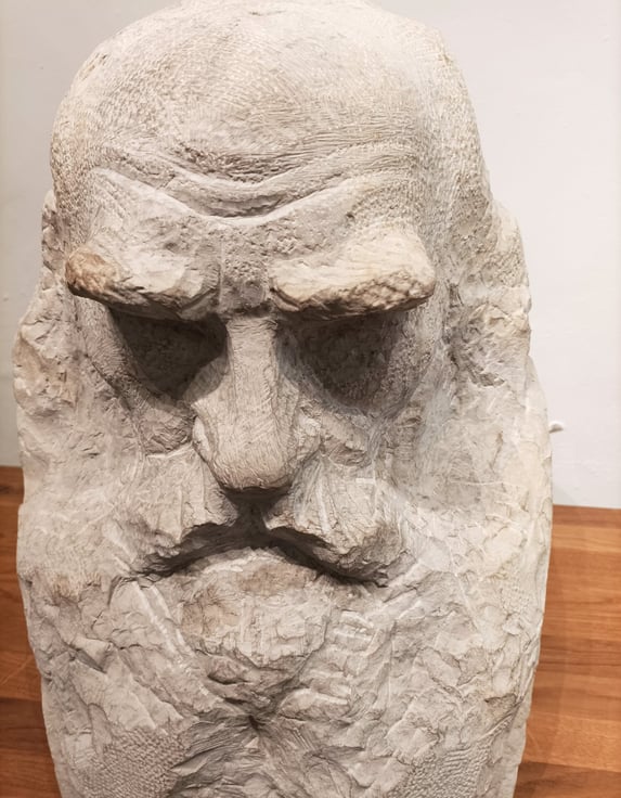 A bust of Tolstoy by Paul Dardé hewn in the local stone..