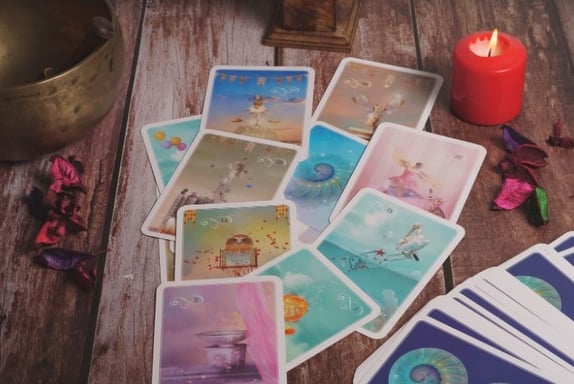 a table with tarot cards and a candle on it