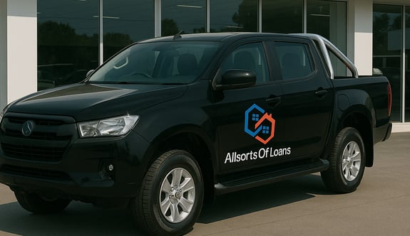a black truck parked in front of a new car
