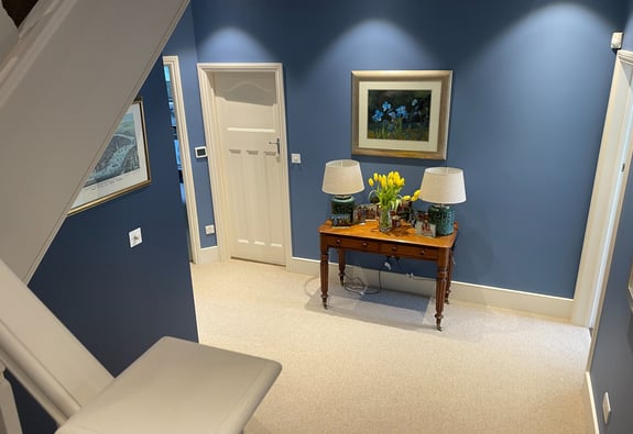 Blue-painted hallway with white doors and trim, professionally finished by Pure Perfection in London