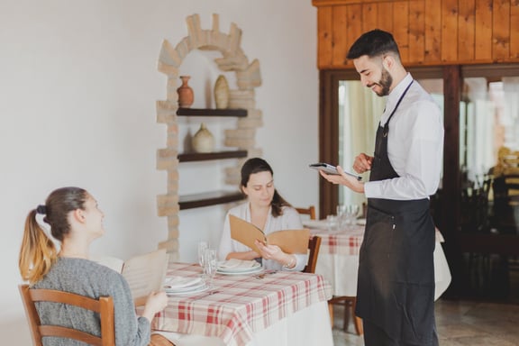 a waiter in a restaurant setting with a waiter