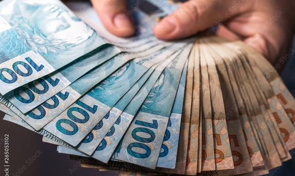 a person holding a bunch of money bills