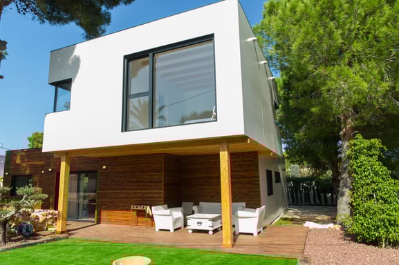 a house with a deck and a deck with chairs