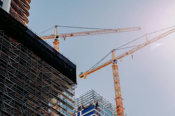 a crane is standing in front of a building