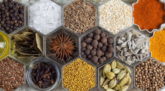 a tray of whole spices and some powdered.